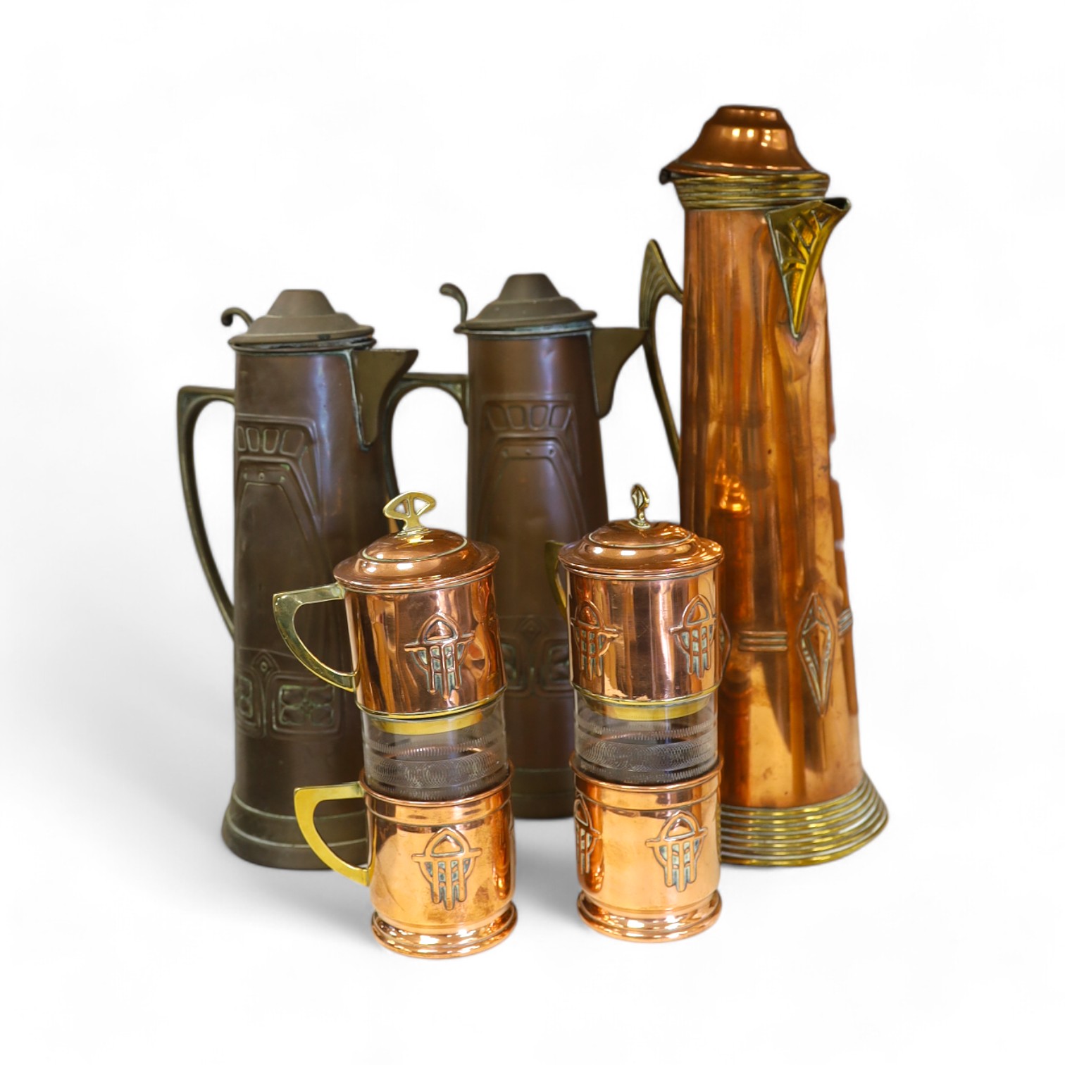 Three Art Nouveau mixed copper and brass coffee pots and two individual copper filter coffee glasses, tallest 36cm high (5). Condition - two pots need cleaning, but good condition for age